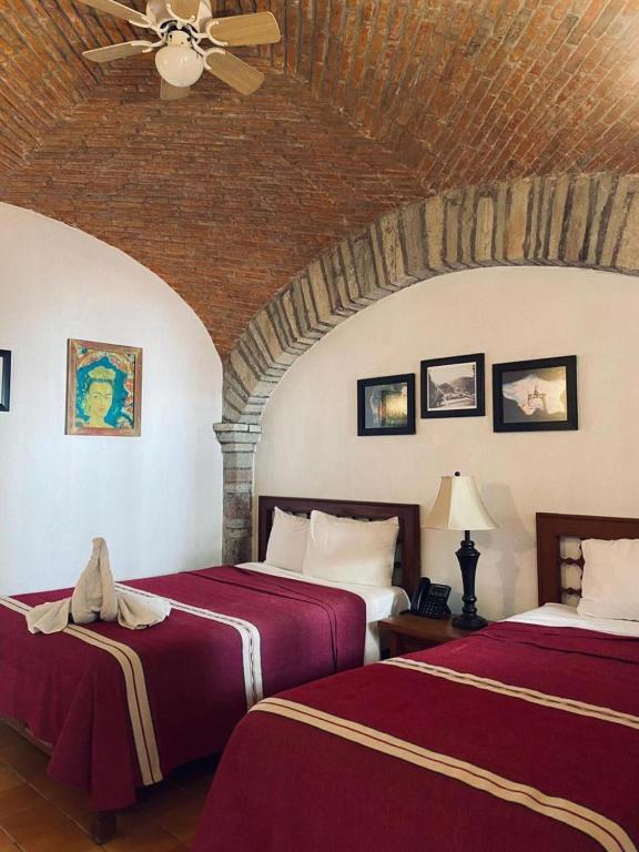 Postel nebo postele na pokoji v ubytování Hotel Socavon