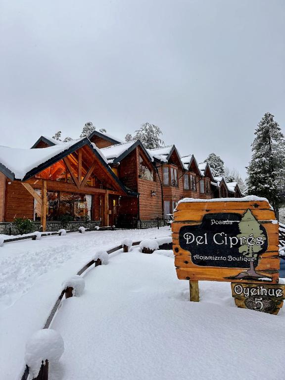 a sign in the snow in front of a lodge at Posada del Ciprés in Villa La Angostura