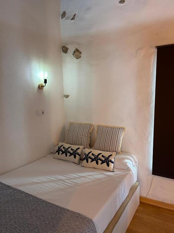 a bed with two pillows on it in a room at Altea Serenity in Altea