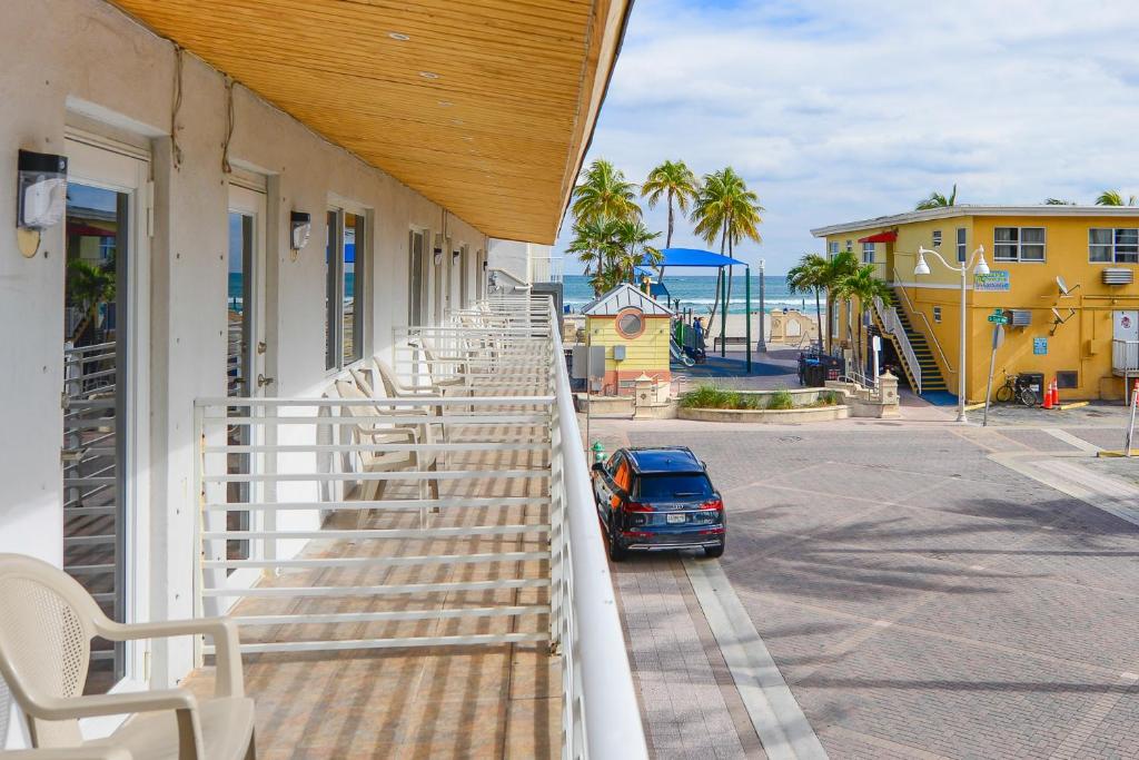 a balcony with chairs and a car parked on the street at Amazing Balcony Studio at the beach with Parking -M44 in Hollywood