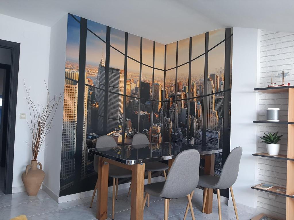 a dining room with a view of the city at Piso Camiño Vello in Negreira