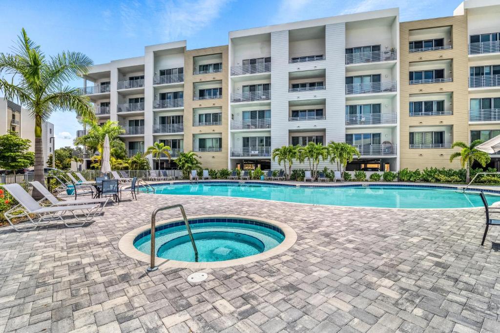 a swimming pool in front of a large building at Waterfront, Pet-Friendly Condo with Pool, Spa, and Fitness Center near Downtown Sarasota in Sarasota