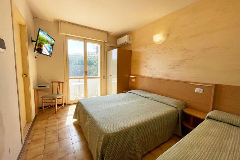 Postel nebo postele na pokoji v ubytování Hotel Cinzia
