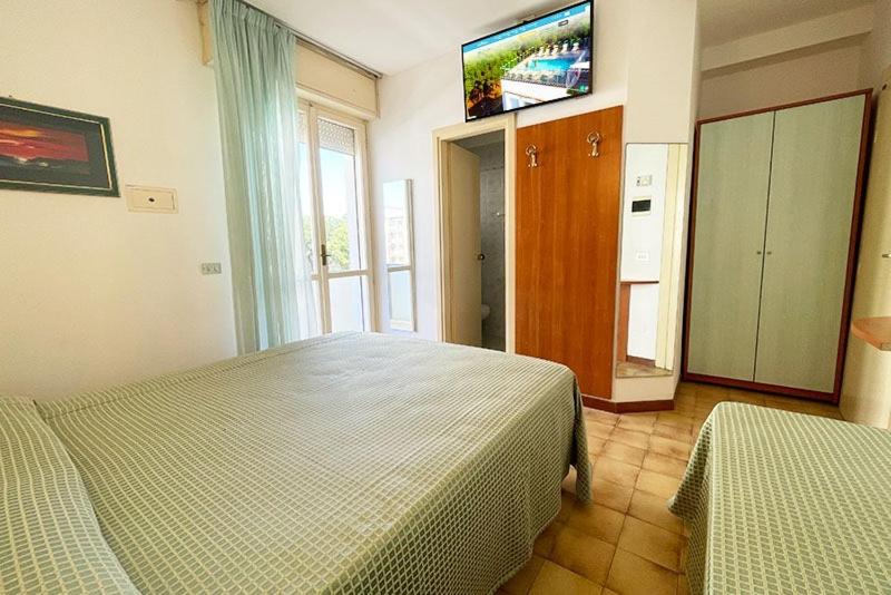 Postel nebo postele na pokoji v ubytování Hotel Cinzia