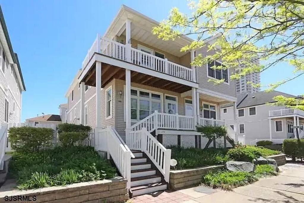 a large white house with a staircase in front of it at Seaside Serenity AC- newly updated Ocean View Home -3 bed 2 bath in Atlantic City