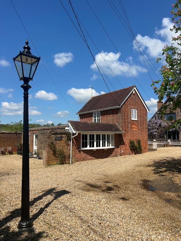 a street light in front of a brick house at Stablehurst Cottage in West Hoathley