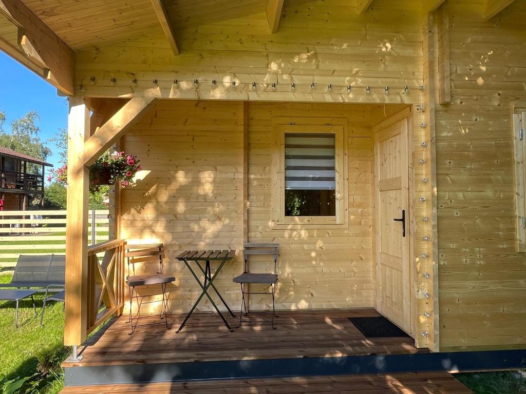 a wooden shed with two chairs and a table at Saulkrasti Beach Cottage in Saulkrasti