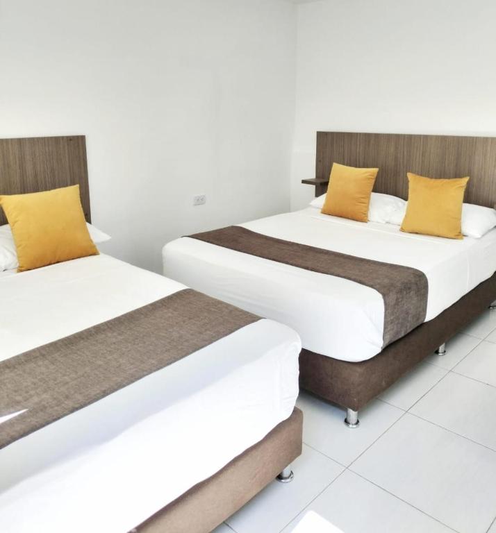 Letto o letti in una camera di Ayenda Hotel Helenas