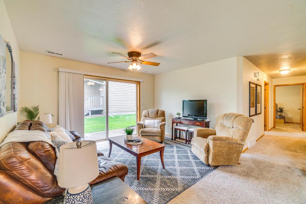 a living room with a couch and chairs and a tv at Cozy Sioux Falls House - Walk to Park! in Sioux Falls