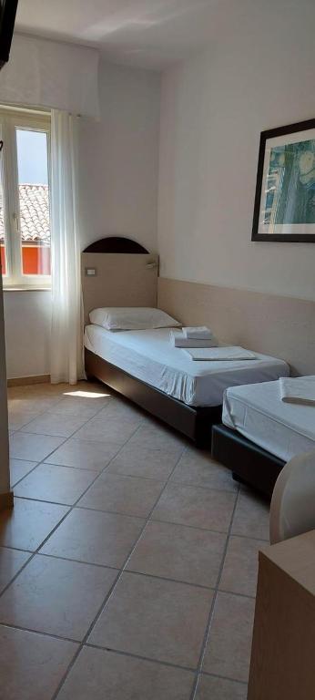 Postel nebo postele na pokoji v ubytování Hotel Sirena