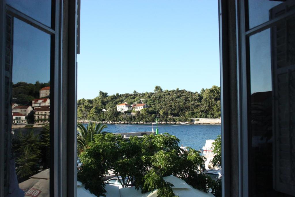 a window with a view of a body of water at Apartment Ivan in Račišće