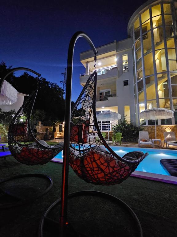 two baskets on a pole in front of a pool at Kopernikus Apartments in Ulcinj