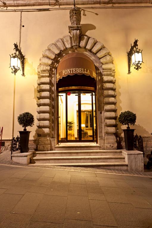 a front door of a building with an archway at Hotel Fontebella in Assisi