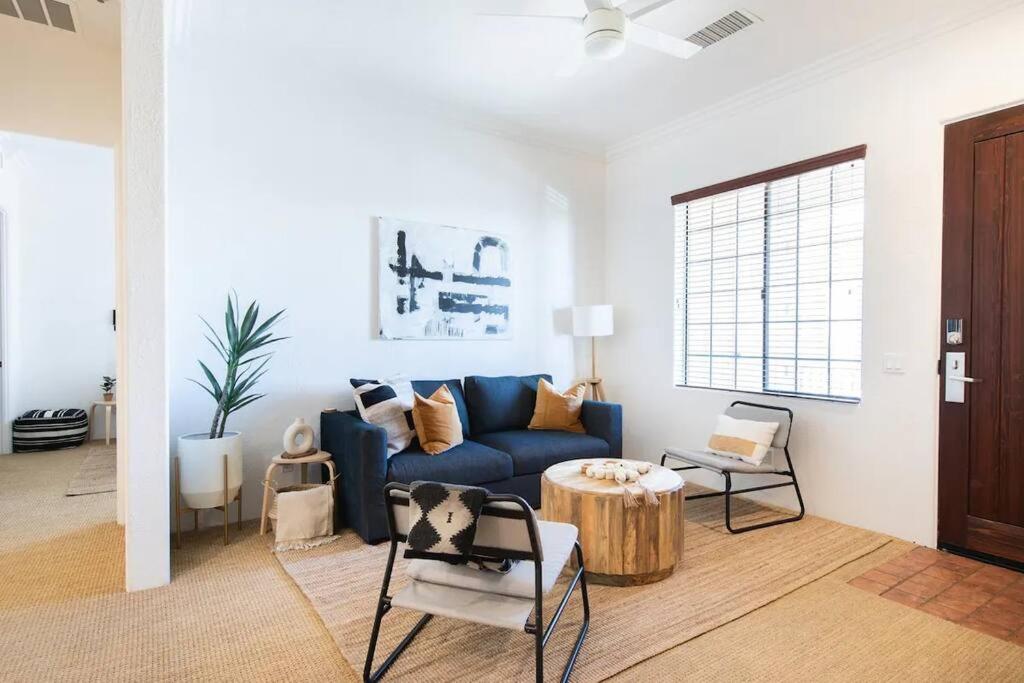 a living room with a blue couch and a table at The Monarch - Chic 1BR Pools and Views in Old Town La Quinta in La Quinta