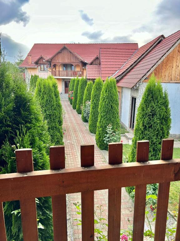 a wooden fence in front of a house at Pensiunea Casa Nina in Cârțișoara