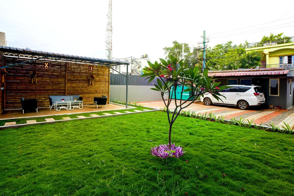 a small tree in the middle of a yard at Elite Enclave - Vento - 2BHK Luxury Serviced Apartments in Mysore