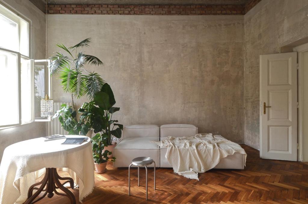 a living room with a white couch and a table at Extraordinary quiet apartment in the very centre in Bratislava