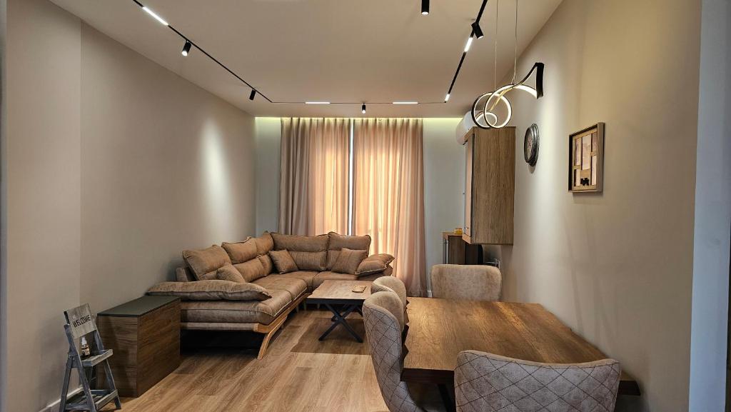 a living room with a couch and a table at Tirana Airport Apartment in Tirana