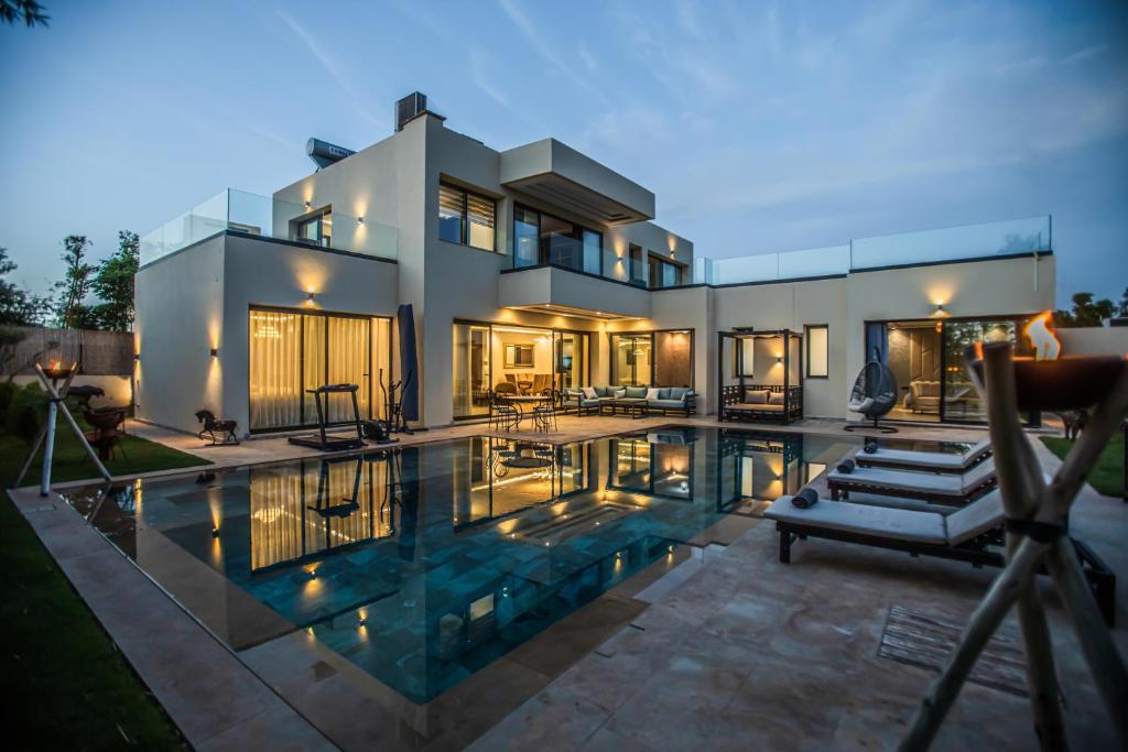 a house with a swimming pool in front of it at AD Villa in Marrakesh