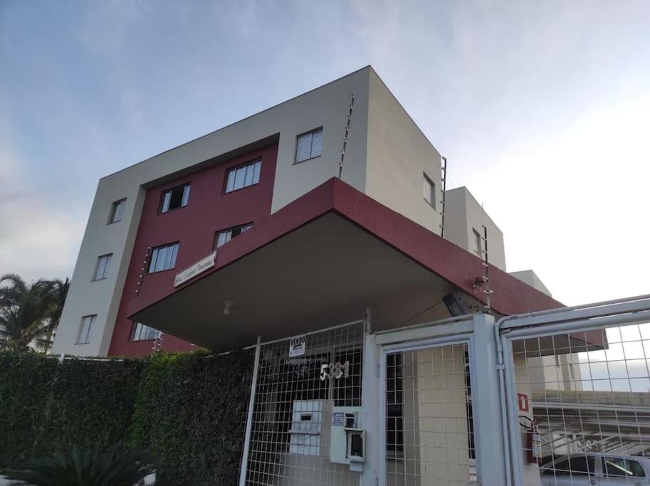 a building with a gate in front of it at Apto no Bairro Alto Umuarama in Uberlândia