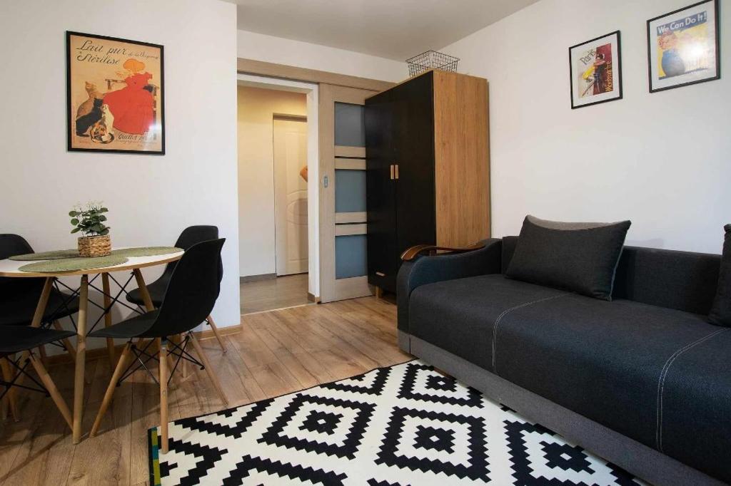a living room with a couch and a table at Apartament Na Parterze in Lesko