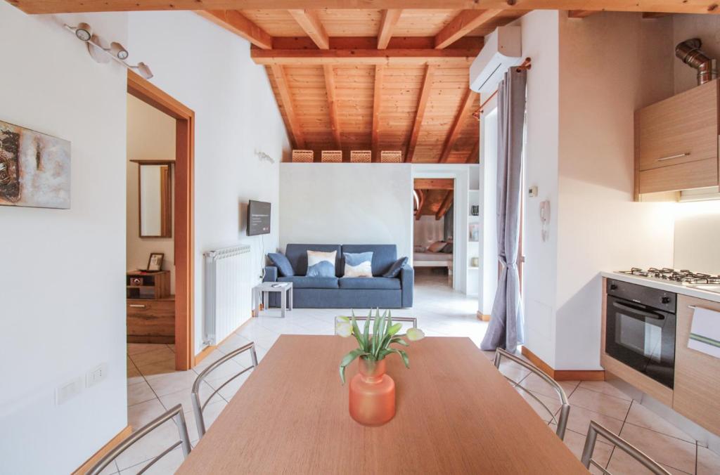 a kitchen and dining room with a table and a couch at Appartamento Maniero 55 in Domaso