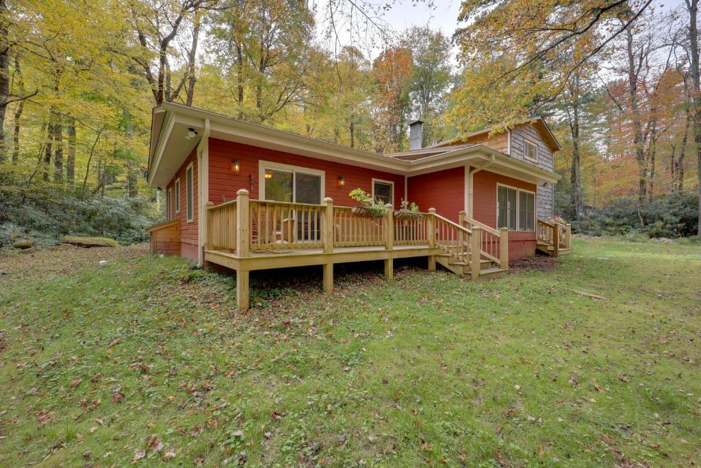 a small red house with a porch and a deck at Creekside Newland Cabin about 7 Mi to Linville Falls in Newland