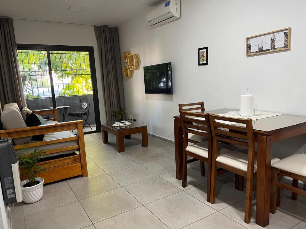 a living room with a dining room table and chairs at Terra Malbec in Godoy Cruz