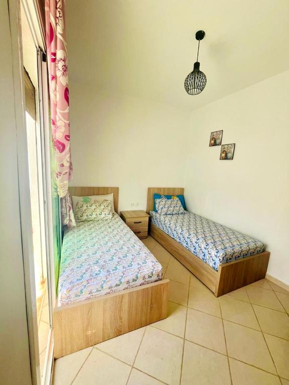 Postel nebo postele na pokoji v ubytování Appartement centre oued laou avec piscine été