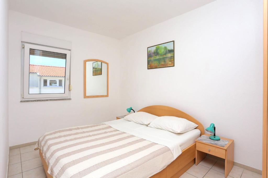 Posteľ alebo postele v izbe v ubytovaní Family friendly apartments with a swimming pool Businci, Ciovo - 11232