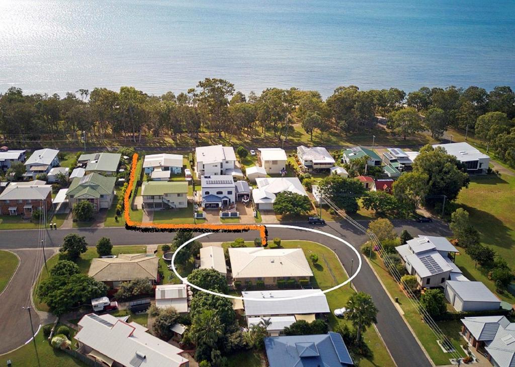 an aerial view of a city with houses and the ocean at Sandy Paws - Burrum Heads- Walk to Beach -3BR- Aircon-Pool table in Burrum Heads