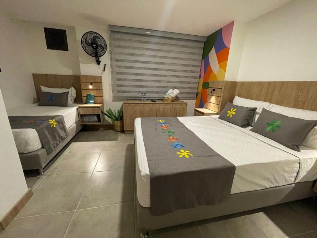 Postel nebo postele na pokoji v ubytování Hotel Medallo City