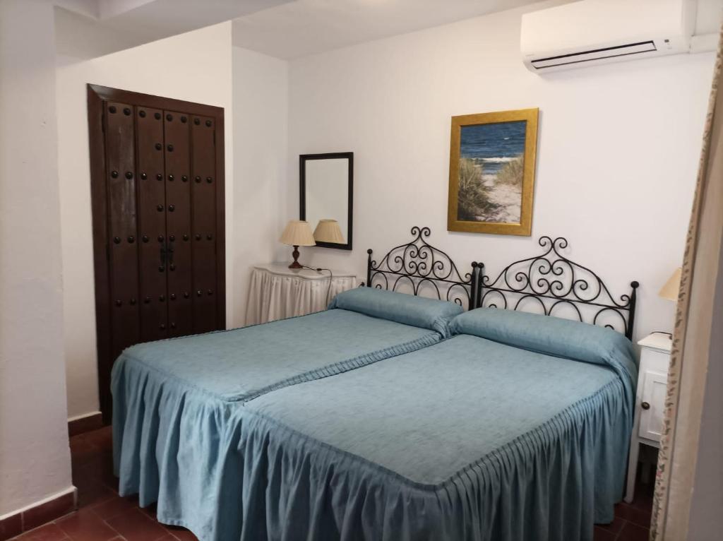 Postel nebo postele na pokoji v ubytování Hostal Gran Capitan