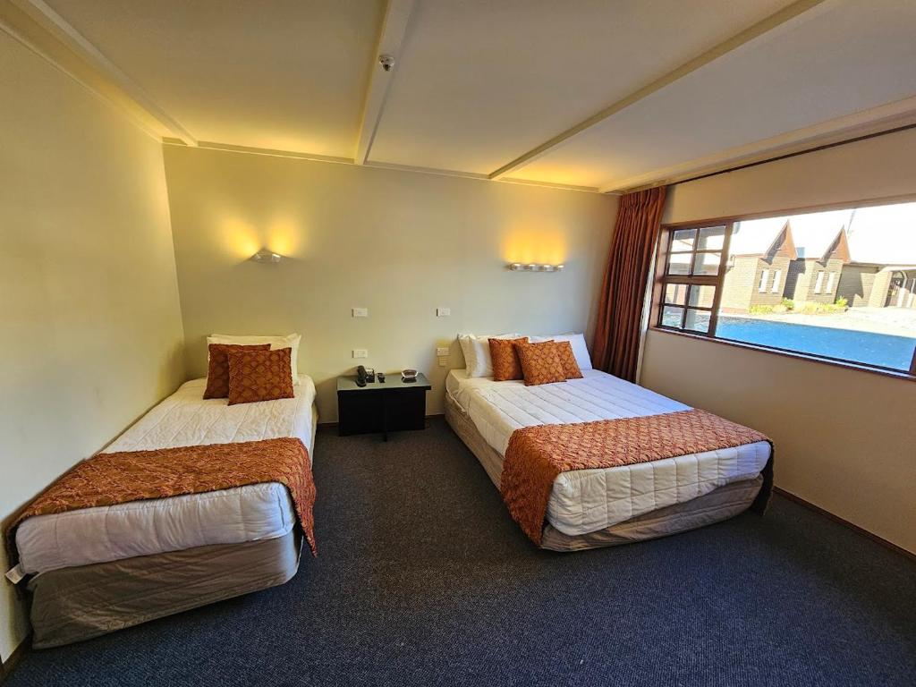 Postel nebo postele na pokoji v ubytování Discovery Countrytime Hotel