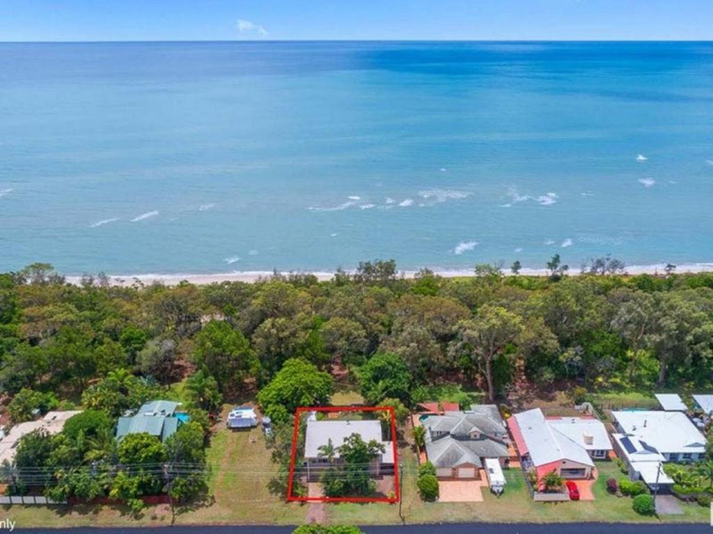 an aerial view of a house and the beach at Kingfisher by the Sea in Toogoom