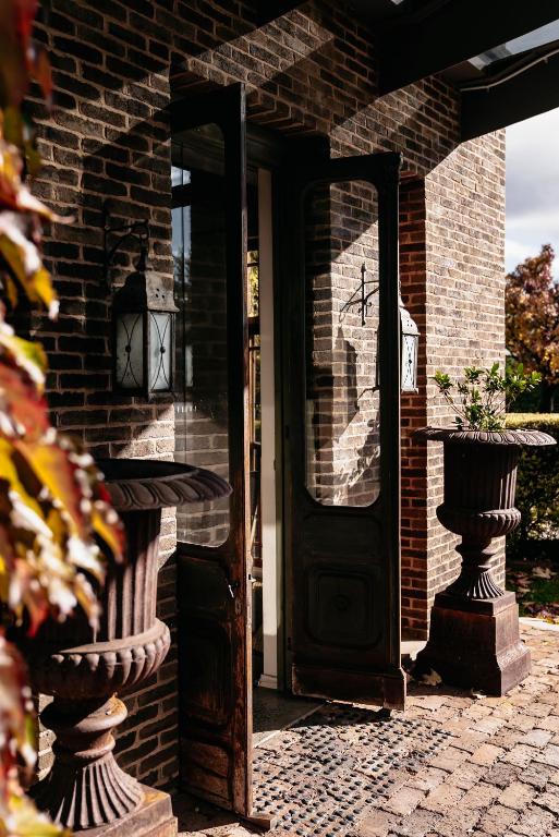 an open door to a brick house with at de Russie Boutique Hotel in Orange