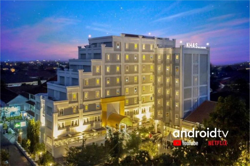 a large white building at night with lights at KHAS Malioboro Hotel in Yogyakarta