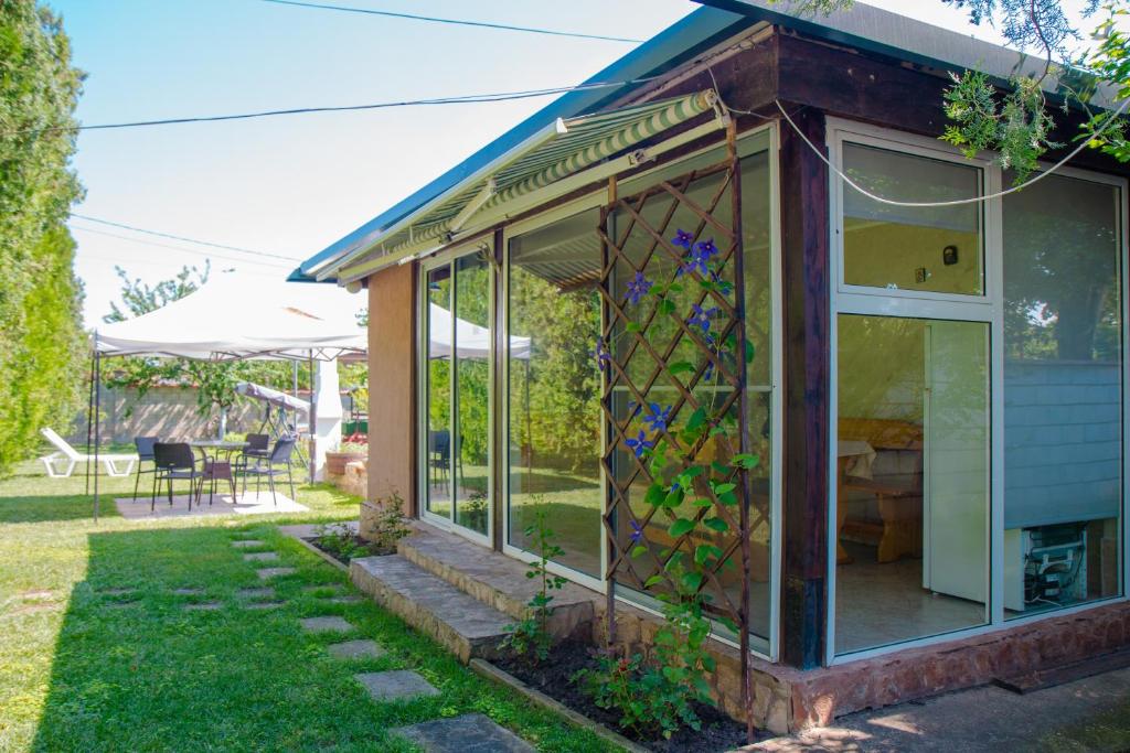 a house with a stained glass window in a yard at Summer House Christie in Krapets