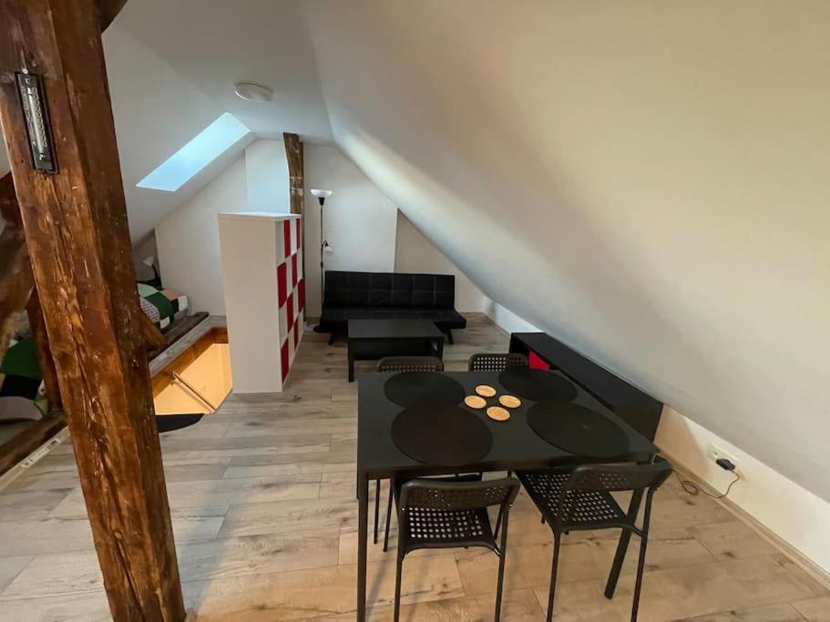 a living room with a table and chairs and a staircase at Francis Apartment II - Spa Center Karlovy Vary in Karlovy Vary