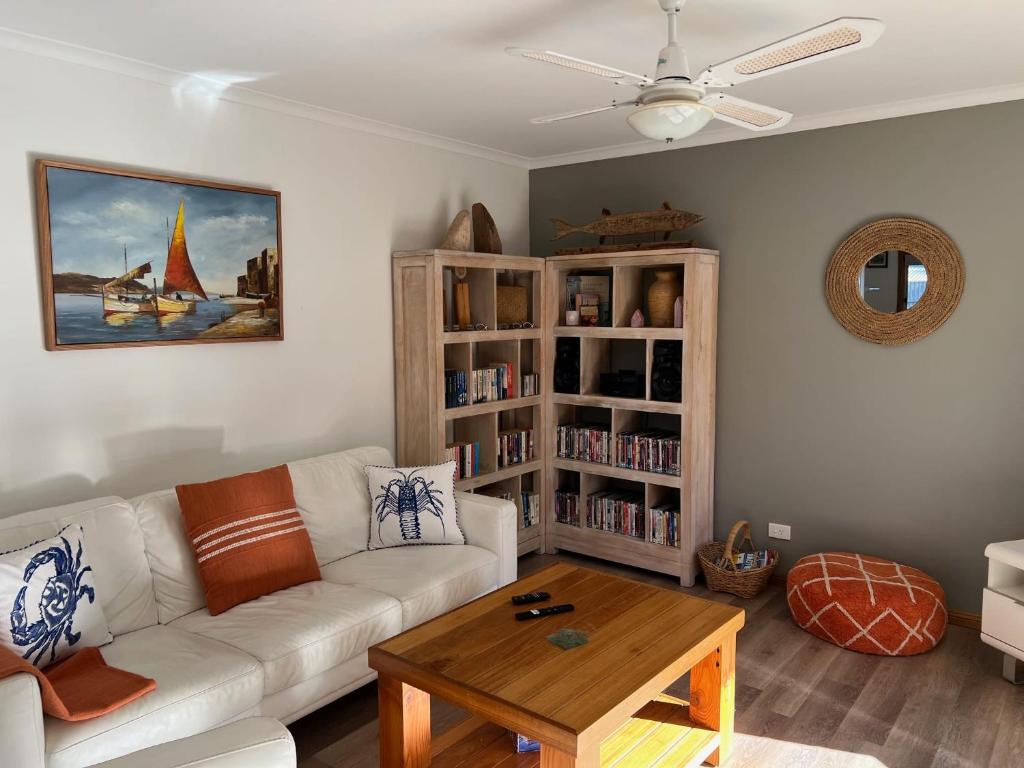 a living room with a white couch and a coffee table at Lazy Sails Port - Pets welcome inside WiFi in Robe