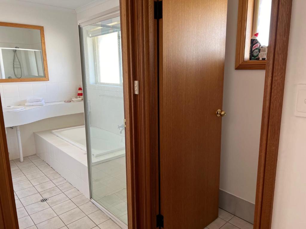 a bathroom with a shower and a bath tub at Lazy Sails Port - Pets welcome inside WiFi in Robe