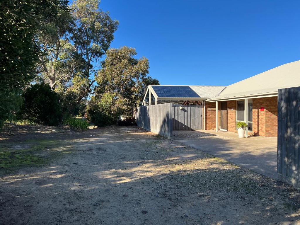 an empty driveway in front of a house at Lazy Sails Port - Pets welcome inside WiFi in Robe