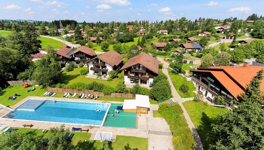 an aerial view of a house with a swimming pool at Ferienwohnungen im Feriendorf Reichenbach Nr 9 in Nesselwang
