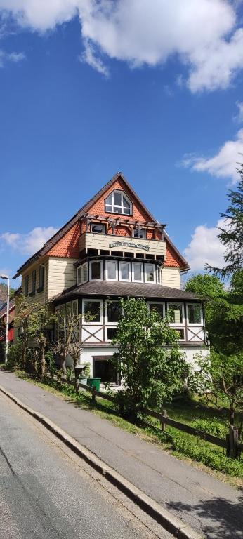 a large house on the side of a road at Altes Forsthaus Fischbach in Sankt Andreasberg