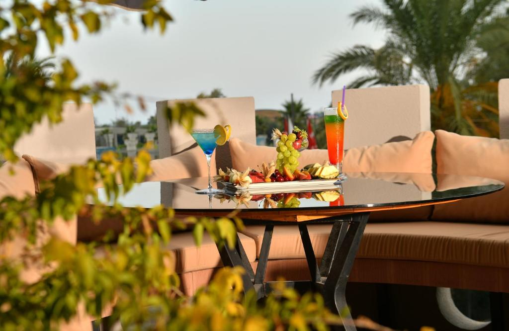 a table with a plate of food on it at Miarosa Kemer Beach in Kemer