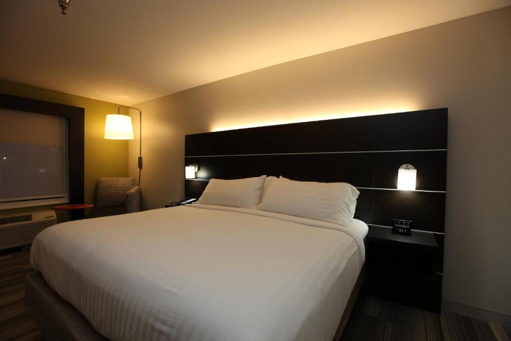 a large white bed in a hotel room with a television at Holiday Inn Express & Suites Chattanooga-Hixson by IHG in Hixson