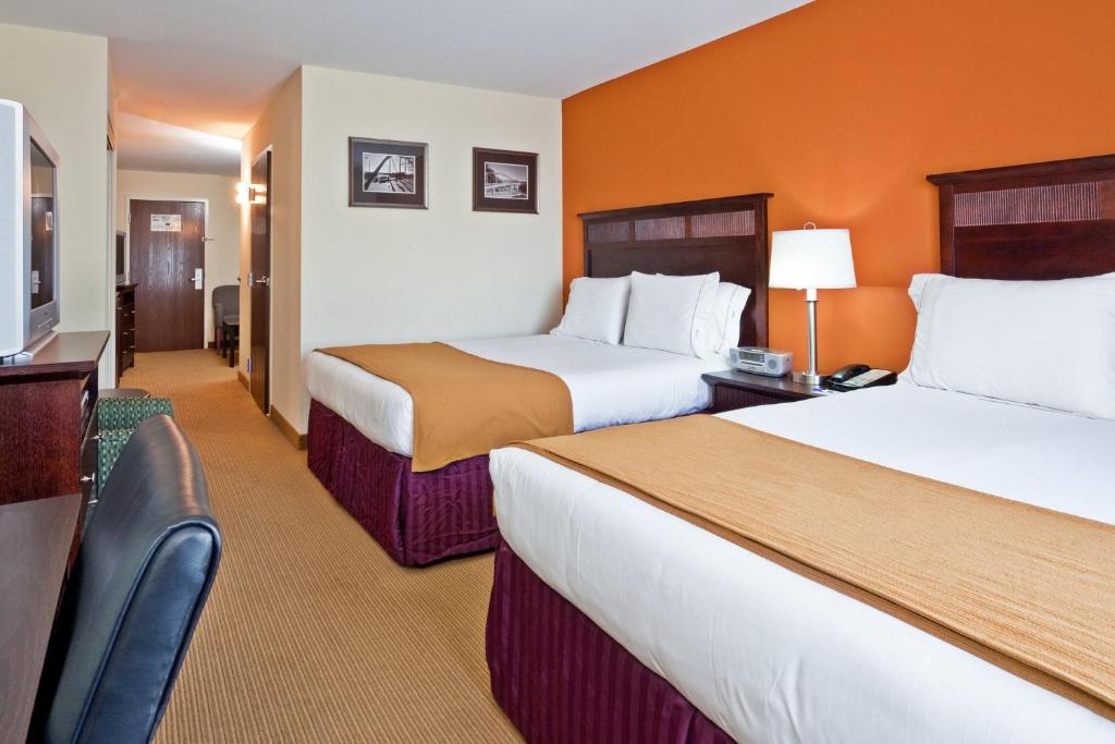 a hotel room with two beds and a television at Holiday Inn Express & Suites Chattanooga-Hixson by IHG in Hixson