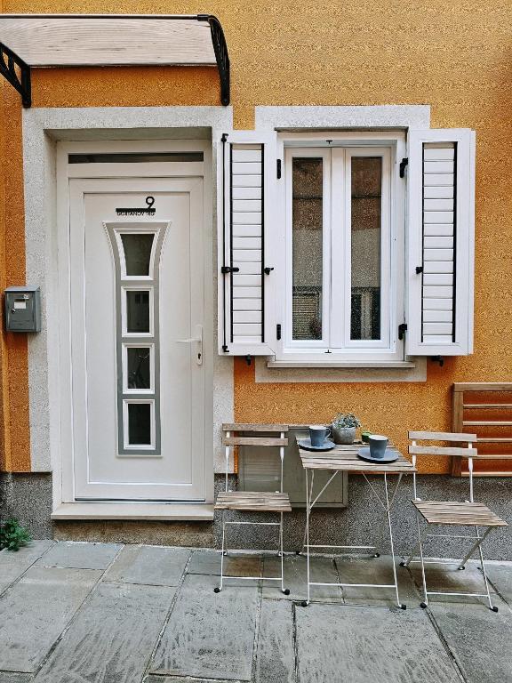 a building with a door and a table and chairs at Apartment Astina in Koper