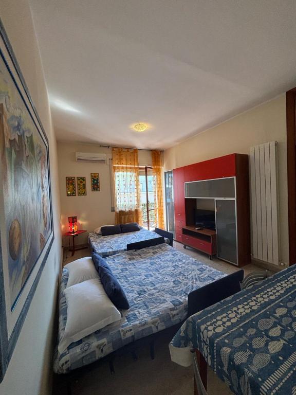 una camera d'albergo con due letti e una tv di Casa Talassa a Pescara