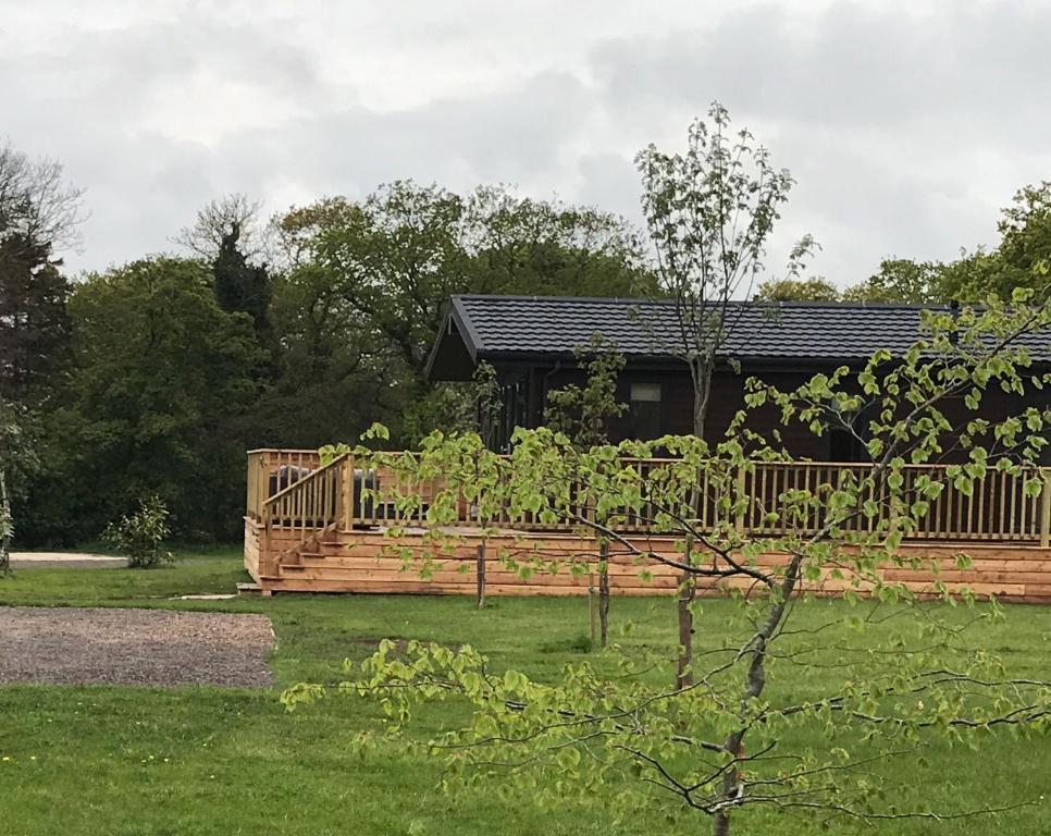 a house with a wooden fence in a yard at Ebba Lodge in Eyemouth